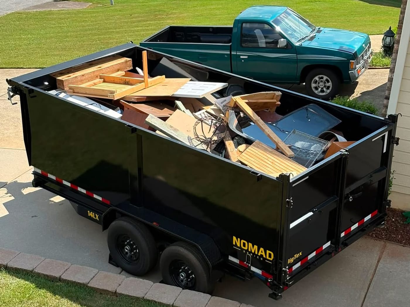 The N. Georgia Junk 15-yard dump trailer parked in a residential driveway, loaded during a 48-hour rental in Woodstock, GA